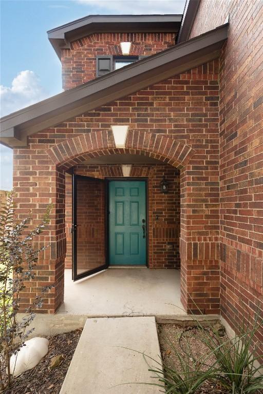 9001 Edmundsbury Dr, Austin, TX 78747 - view of exterior entry featuring brick siding
