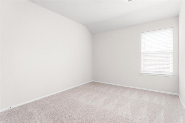 2800 Joe Dimaggio Blvd Unit 100, Round Rock, TX 78665 - empty room featuring carpet flooring and vaulted ceiling