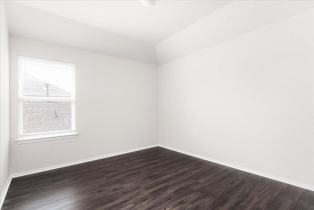 2800 Joe Dimaggio Blvd Unit 100, Round Rock, TX 78665 - spare room featuring dark wood-style flooring and vaulted ceiling