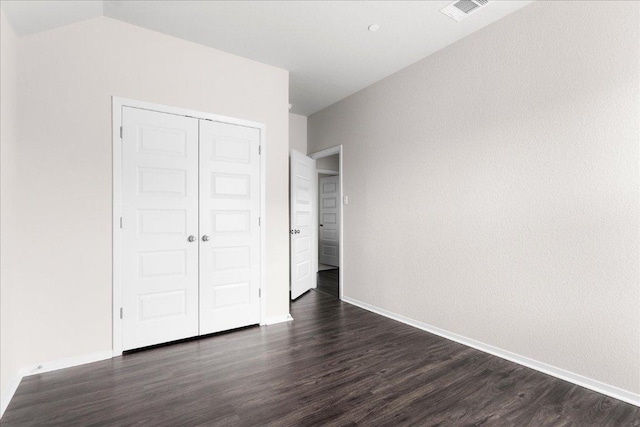 2800 Joe Dimaggio Blvd Unit 100, Round Rock, TX 78665 - unfurnished bedroom featuring dark wood finished floors and a closet