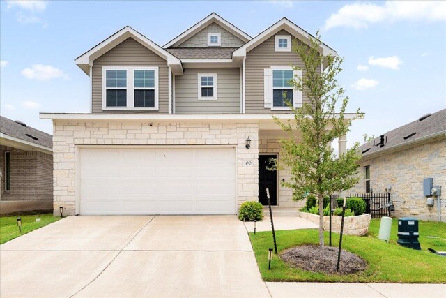 2800 Joe Dimaggio Blvd Unit 100, Round Rock, TX 78665 - view of front of house featuring stone siding, an attached garage, and driveway