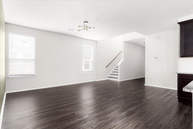 2800 Joe Dimaggio Blvd Unit 100, Round Rock, TX 78665 - unfurnished living room with stairs, dark wood-style floors, and a chandelier