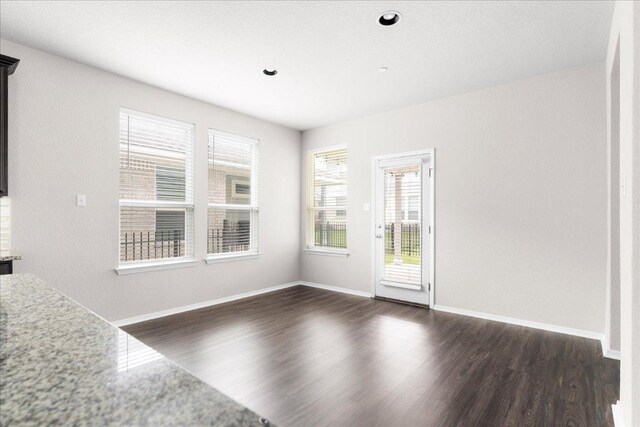 2800 Joe Dimaggio Blvd Unit 100, Round Rock, TX 78665 - unfurnished living room featuring dark wood-style floors and recessed lighting