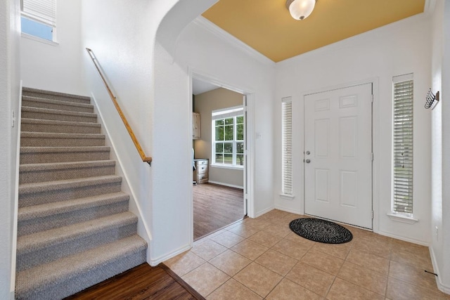 1813 Indian Lodge Dr, Cedar Park, TX 78613 - foyer featuring crown molding, stairway, light tile patterned flooring, and arched walkways