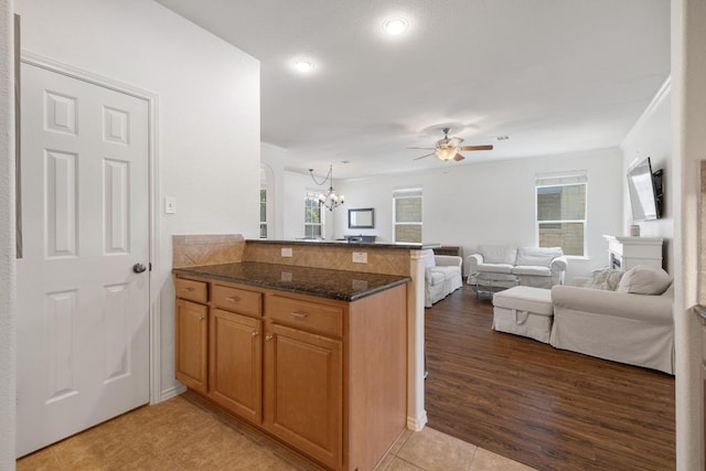 1813 Indian Lodge Dr, Cedar Park, TX 78613 - kitchen featuring a peninsula, open floor plan, a chandelier, ceiling fan, and dark stone countertops