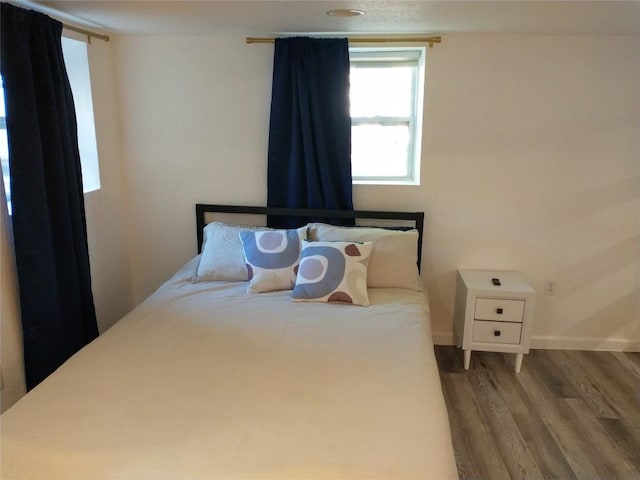 1003 E 13th St Unit 1, Austin, TX 78702 - bedroom featuring wood finished floors and baseboards
