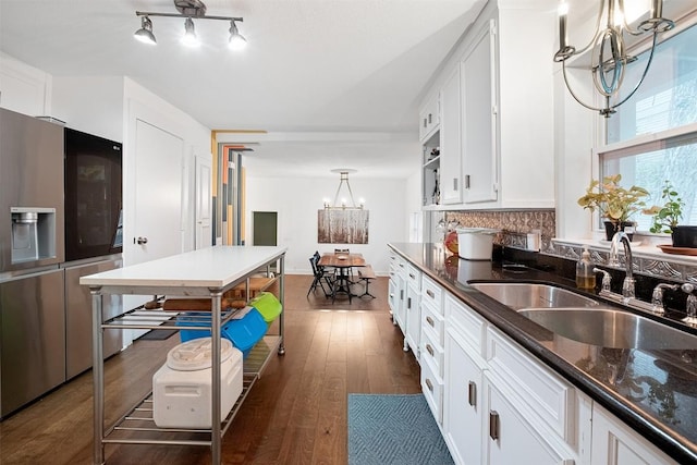 1003 E 13th St Unit 1, Austin, TX 78702 - kitchen featuring a chandelier, refrigerator with ice dispenser, a sink, decorative backsplash, and white cabinetry