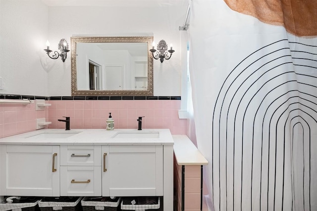 1003 E 13th St Unit 1, Austin, TX 78702 - bathroom featuring tile walls, double vanity, and wainscoting
