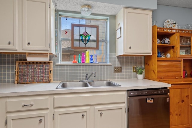 534 Broken Feather Trl, Pflugerville, TX 78660 - kitchen featuring dishwashing machine, light countertops, decorative backsplash, white cabinetry, and a textured ceiling