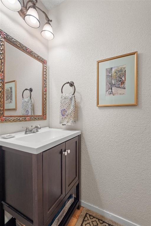 534 Broken Feather Trl, Pflugerville, TX 78660 - bathroom with vanity and a textured wall