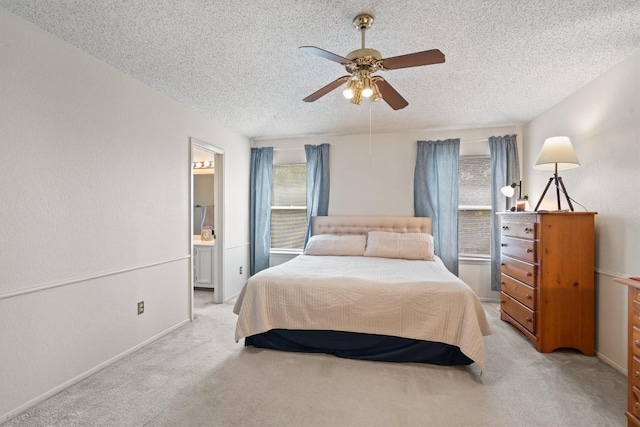 534 Broken Feather Trl, Pflugerville, TX 78660 - bedroom featuring a textured ceiling, light colored carpet, ensuite bath, and a ceiling fan