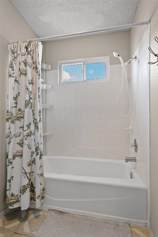 534 Broken Feather Trl, Pflugerville, TX 78660 - full bathroom with shower / bath combo with shower curtain and a textured ceiling