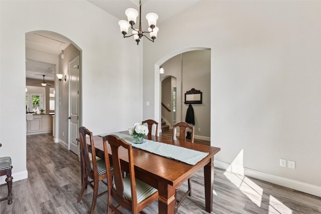 104 Blue Agave Ln, Georgetown, TX 78626 - dining space with wood finished floors, arched walkways, baseboards, and stairway