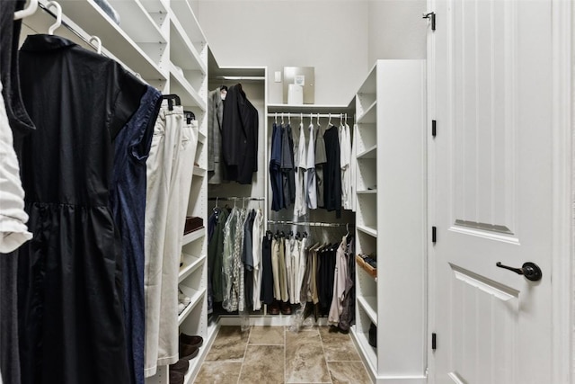 104 Blue Agave Ln, Georgetown, TX 78626 - walk in closet featuring stone finish floors
