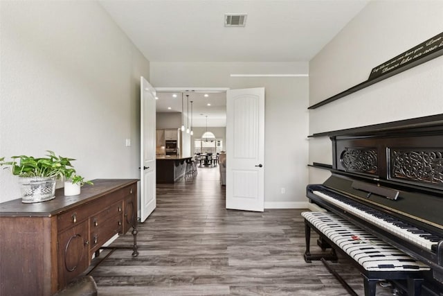 104 Blue Agave Ln, Georgetown, TX 78626 - living area featuring dark wood-style flooring and baseboards