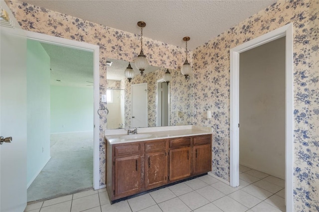 8546 Red Willow Dr, Austin, TX 78736 - bathroom with a textured ceiling, wallpapered walls, vanity, and tile patterned flooring