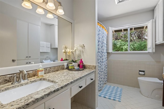 108 Highlander St, Lakeway, TX 78734 - bathroom featuring tile patterned flooring, vanity, tile walls, a wainscoted wall, and a shower with shower curtain