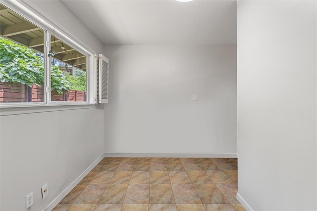 108 Highlander St, Lakeway, TX 78734 - empty room with baseboards and stone finish flooring