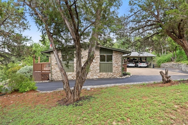 108 Highlander St, Lakeway, TX 78734 - view of side of home with stone siding and asphalt driveway