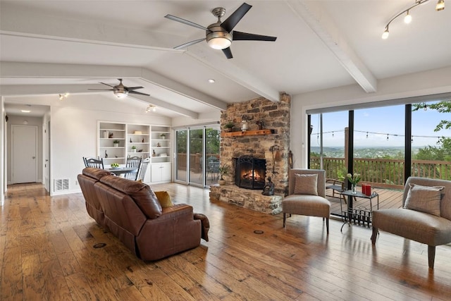 108 Highlander St, Lakeway, TX 78734 - living area featuring ceiling fan, hardwood / wood-style floors, a fireplace, and built in shelves