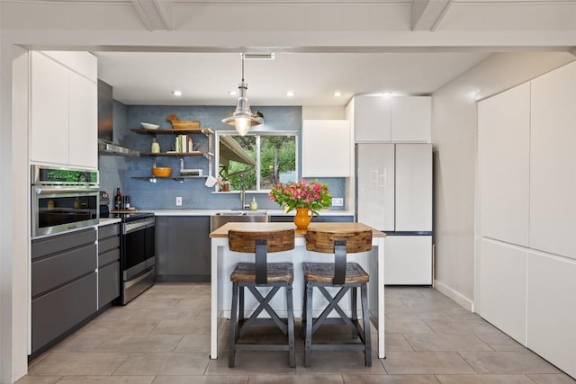 108 Highlander St, Lakeway, TX 78734 - kitchen with appliances with stainless steel finishes, decorative backsplash, white cabinets, light countertops, and beamed ceiling