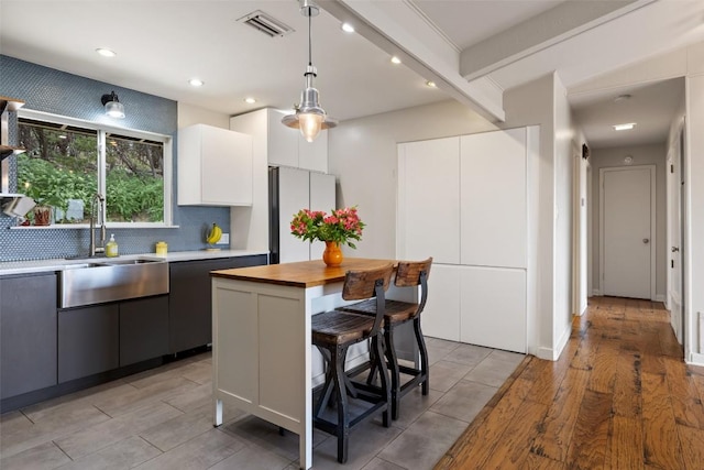 108 Highlander St, Lakeway, TX 78734 - kitchen featuring freestanding refrigerator, butcher block counters, recessed lighting, decorative light fixtures, and backsplash