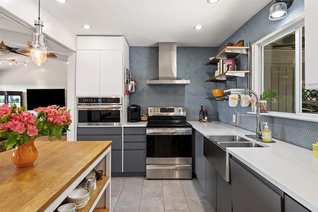 108 Highlander St, Lakeway, TX 78734 - kitchen with stainless steel appliances, wall chimney exhaust hood, open shelves, tasteful backsplash, and recessed lighting