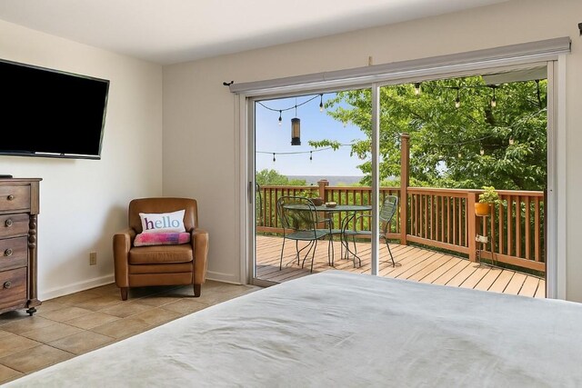 108 Highlander St, Lakeway, TX 78734 - tiled bedroom featuring access to exterior and baseboards