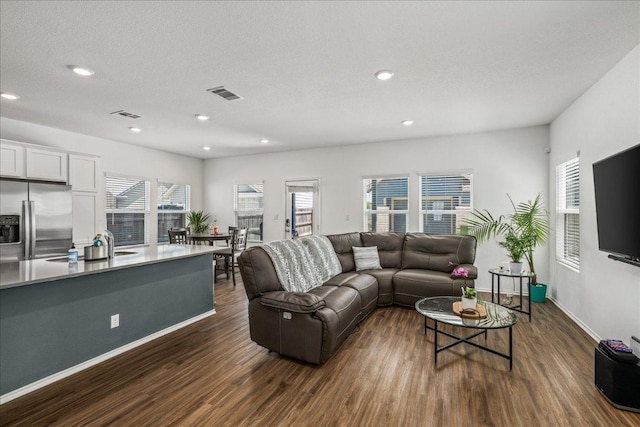 1725 Cobblecrest Ln, Leander, TX 78641 - living room with dark wood-style floors and recessed lighting