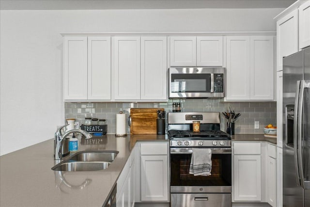 1725 Cobblecrest Ln, Leander, TX 78641 - kitchen with appliances with stainless steel finishes, backsplash, and white cabinetry