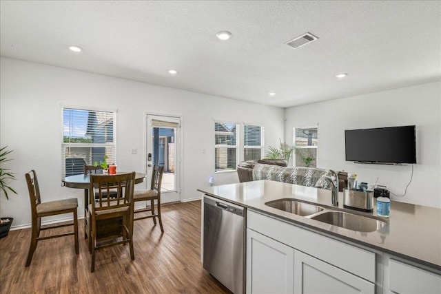 1725 Cobblecrest Ln, Leander, TX 78641 - kitchen with stainless steel dishwasher, open floor plan, plenty of natural light, white cabinetry, and recessed lighting