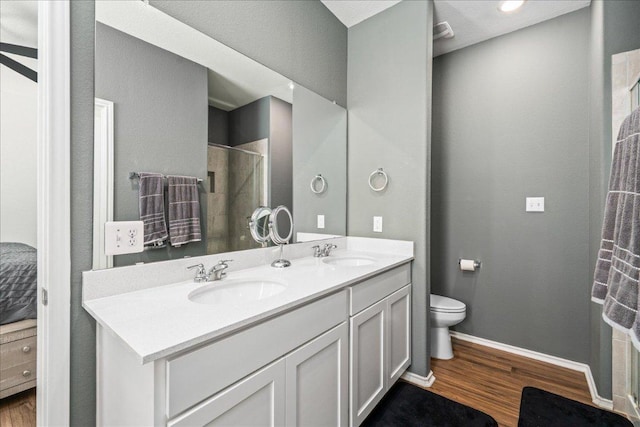 1725 Cobblecrest Ln, Leander, TX 78641 - full bathroom with wood finished floors, double vanity, and a tile shower