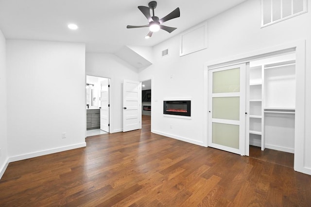 1006 Chericoo St, Austin, TX 78702 - unfurnished living room featuring a ceiling fan, a glass covered fireplace, wood finished floors, recessed lighting, and vaulted ceiling