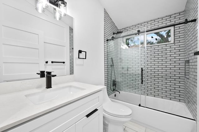 1006 Chericoo St, Austin, TX 78702 - full bath with enclosed tub / shower combo, vanity, toilet, and tile patterned floors