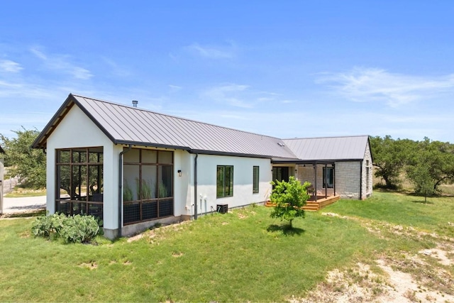 577 Cattle Creek Rd, Johnson City, TX 78636 - back of house featuring stucco siding, metal roof, and a yard