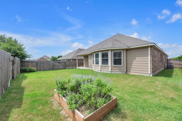 3546 Guadalajara St, Round Rock, TX 78665 - rear view of property featuring a garden, a fenced backyard, and a shingled roof