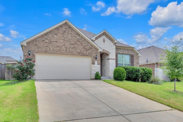 3546 Guadalajara St, Round Rock, TX 78665 - view of front of home with an attached garage, concrete driveway, stone siding, and brick siding
