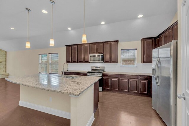 3546 Guadalajara St, Round Rock, TX 78665 - kitchen featuring stainless steel appliances, lofted ceiling, dark brown cabinetry, and decorative light fixtures