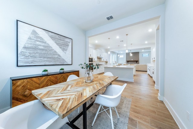 471 Diamondleaf Dr, Buda, TX 78610 - dining area with light wood finished floors, recessed lighting, and baseboards