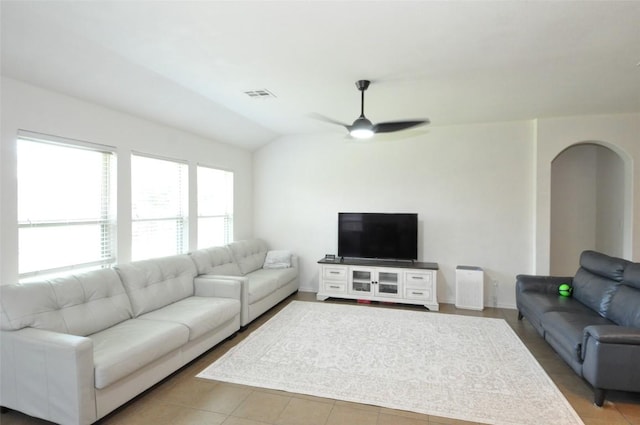 16805 Ruggio Rd, Pflugerville, TX 78660 - living area with ceiling fan, lofted ceiling, arched walkways, tile patterned flooring, and baseboards