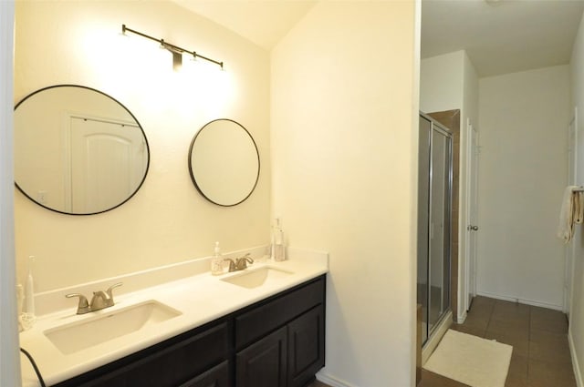 16805 Ruggio Rd, Pflugerville, TX 78660 - bathroom featuring tile patterned floors, double vanity, and a shower stall