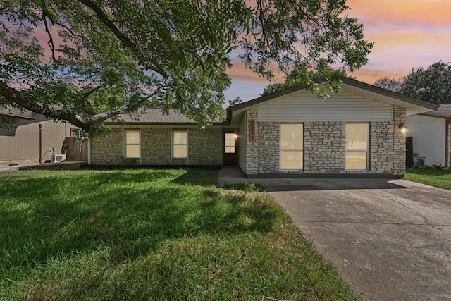 1111 Spearson Ln, Austin, TX 78745 - single story home with a yard, stone siding, and concrete driveway