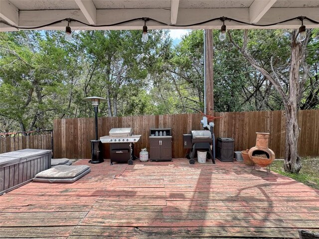 729 Trail Crest Dr, Canyon Lake, TX 78133 - fenced backyard featuring a grill, a deck, and view of wooded area