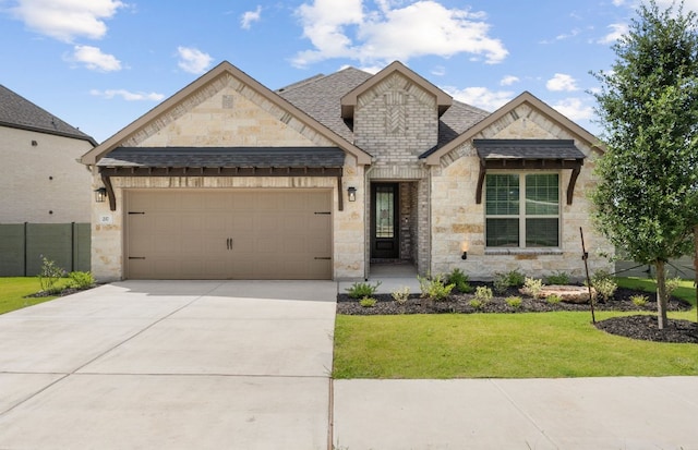 217 Peach Orchard Ln, Georgetown, TX 78628 - french country style house with stone siding, an attached garage, concrete driveway, and a shingled roof