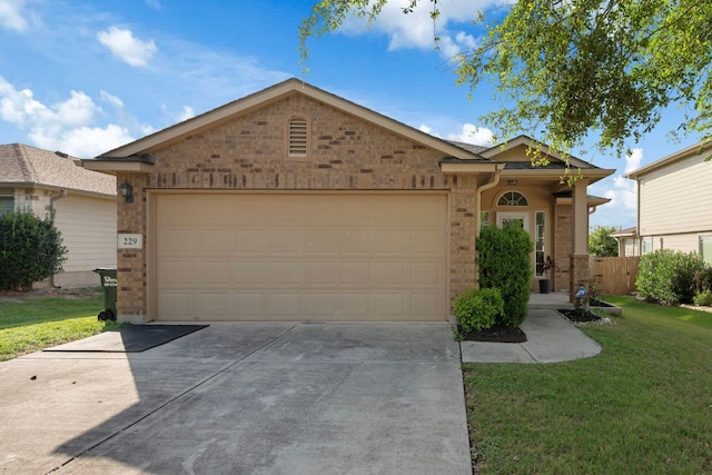 229 Wild Plum, San Marcos, TX 78666 - single story home with brick siding, an attached garage, concrete driveway, and a front lawn