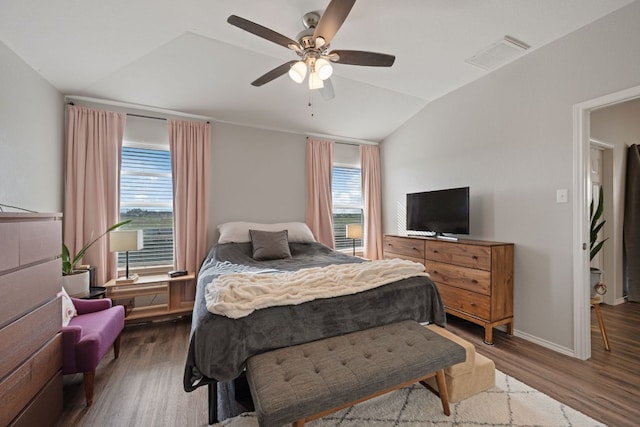229 Wild Plum, San Marcos, TX 78666 - bedroom featuring vaulted ceiling, wood finished floors, multiple windows, and a ceiling fan