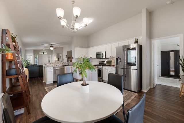 229 Wild Plum, San Marcos, TX 78666 - dining room featuring dark wood-style floors, a chandelier, and a ceiling fan