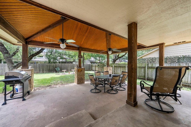 11311 Alhambra Dr, Austin, TX 78759 - fenced backyard with a ceiling fan, outdoor dining space, a patio area, and grilling area