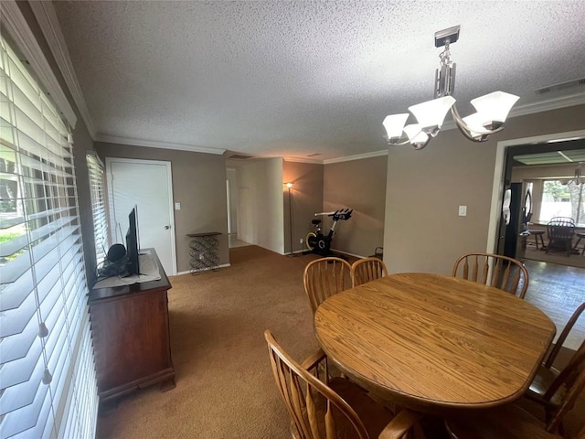 11311 Alhambra Dr, Austin, TX 78759 - carpeted dining space with ornamental molding, a textured ceiling, and a chandelier