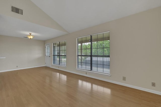 1219 Canyon Trce, Canyon Lake, TX 78133 - spare room with vaulted ceiling and wood finished floors